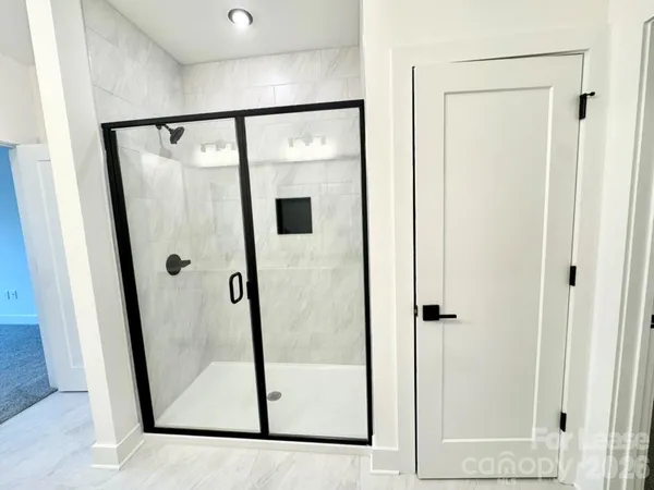 a bathroom with a glass shower door and a sink