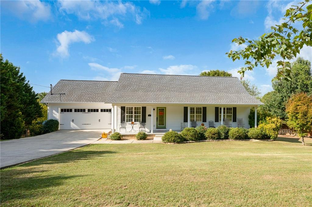a front view of house with yard and green space
