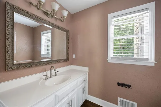 a bathroom with a sink and a mirror