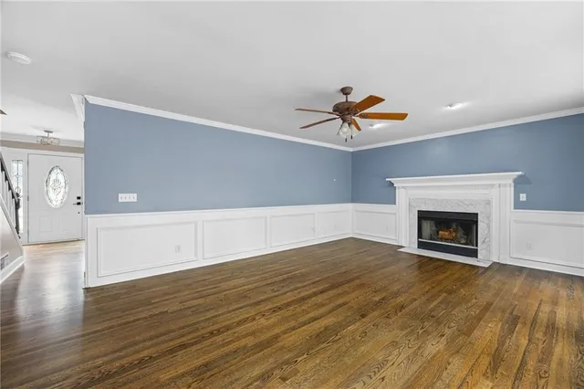 a view of empty room with wooden floor and fireplace