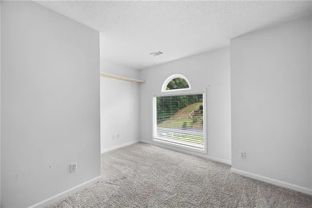 a bathroom with a sink a large mirror and a light fixture