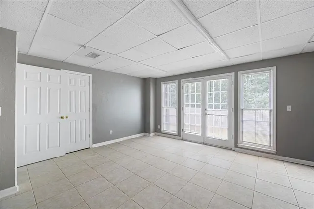 a balcony with wooden floor and trees in the background