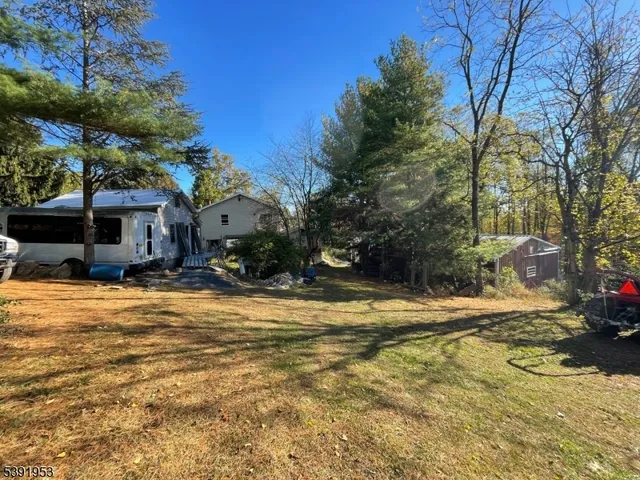 a view of a house with snow on the road