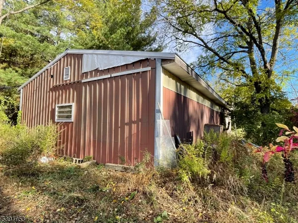 a view of a house with a small yard and plants