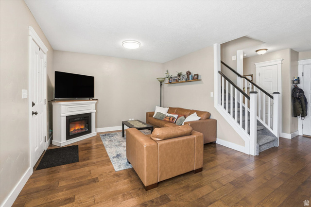 1024 South 270 West Logan, UT 84321 - Photo 5 of 37 Living room featuring dark wood-type flooring and a glass covered fireplace