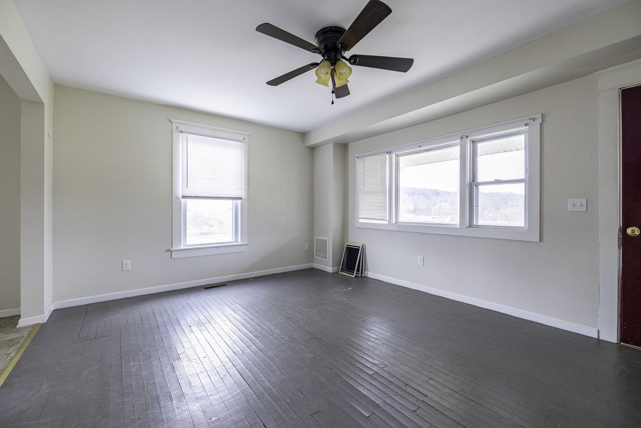 8120 Winestore Road Timberville, VA 22853 - Photo 8 of 35 a view of an empty room with a window and wooden floor