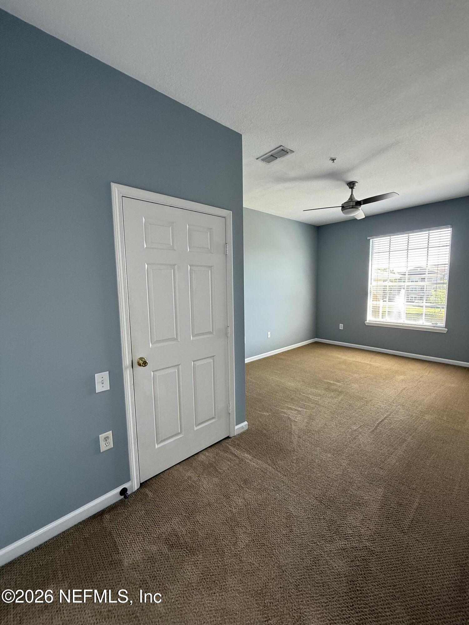 7990 Baymeadows Road, Unit 829 Jacksonville, FL 32256 - Photo 17 of 34 an empty room with windows and closet