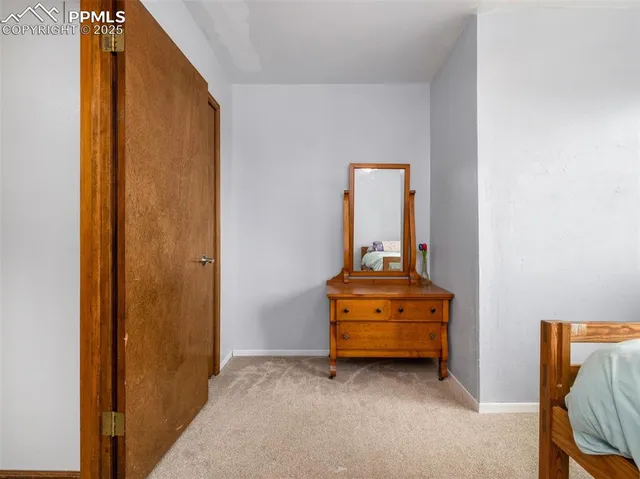 a view of a livingroom with furniture and mirror