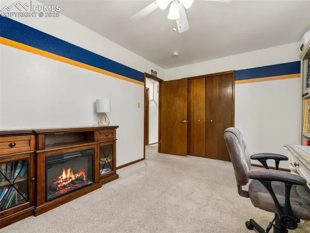 a view of an empty room with furniture and a fireplace