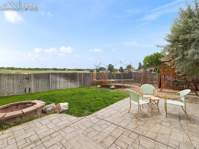 a view of a chair and table on the garden