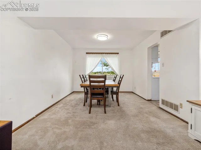 a workspace room with furniture and window