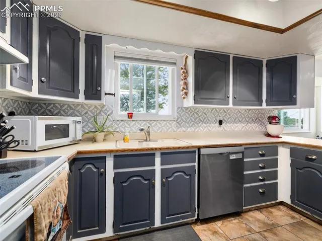 a kitchen with stainless steel appliances granite countertop a sink and a stove