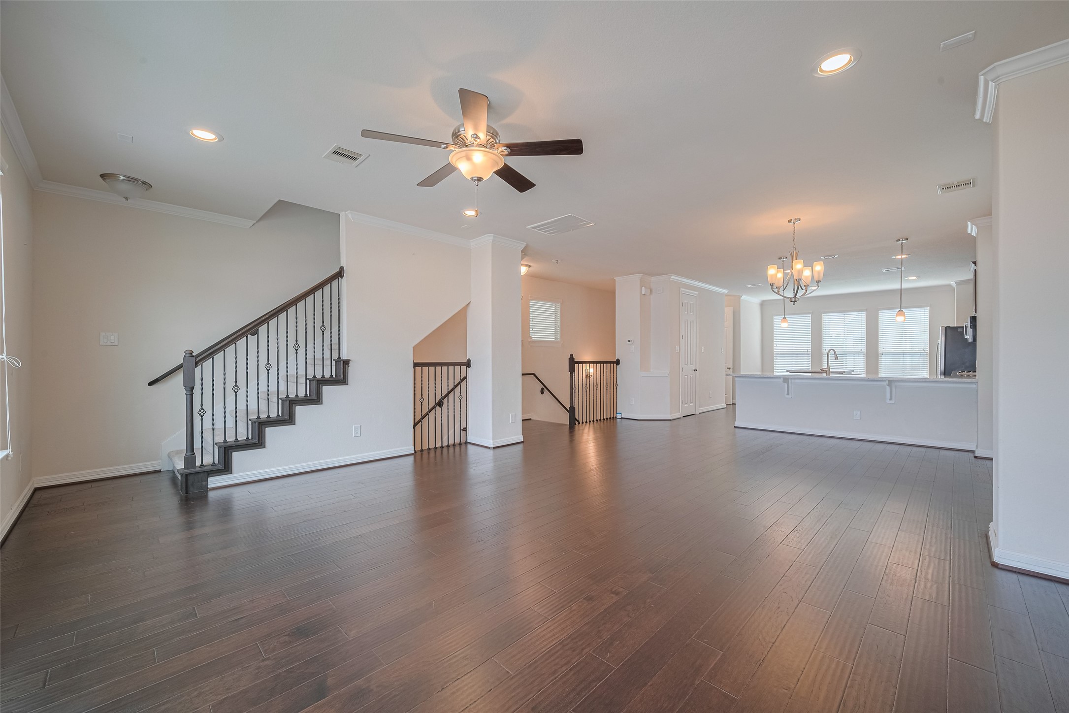 10004 Spring Shadows Park Circle Houston, TX 77080 - Photo 14 of 50 a view of an empty room with wooden floor and a ceiling fan