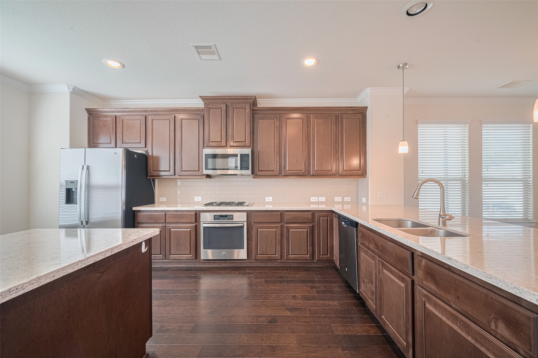 10004 Spring Shadows Park Circle Houston, TX 77080 - Photo 17 of 50 a large kitchen with stainless steel appliances lots of counter space sink and cabinets