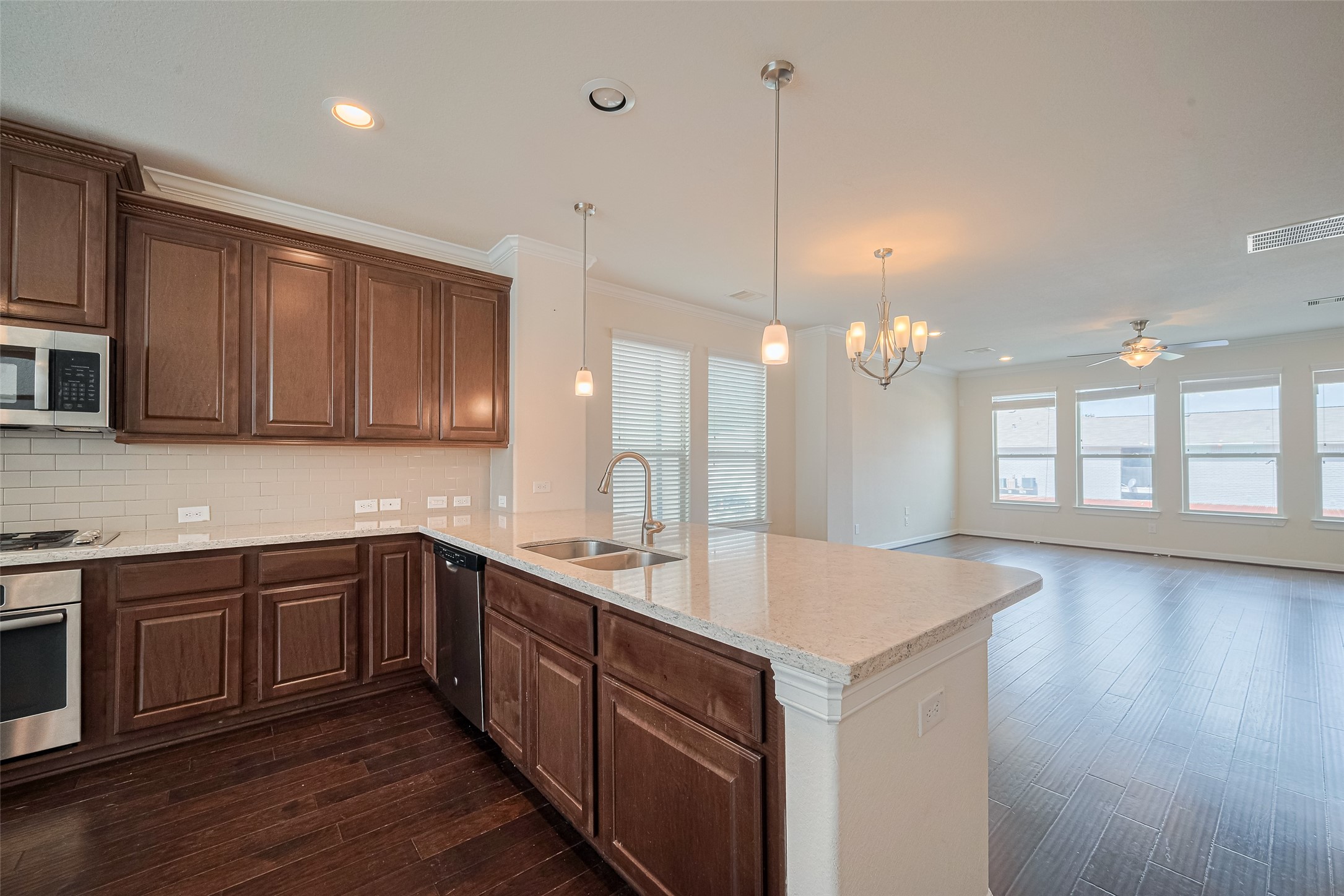 10004 Spring Shadows Park Circle Houston, TX 77080 - Photo 18 of 50 a kitchen with a sink cabinets and wooden floor