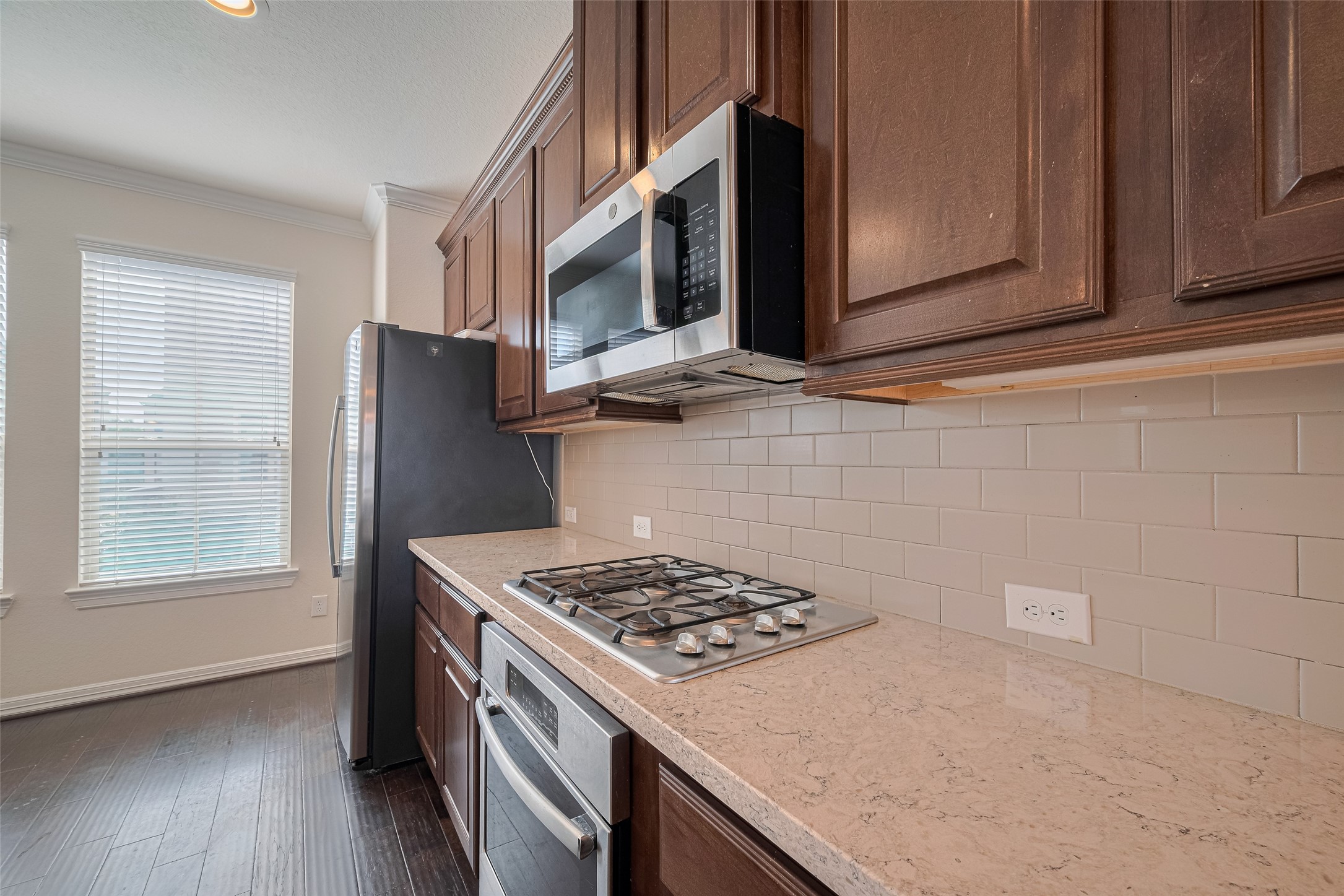 10004 Spring Shadows Park Circle Houston, TX 77080 - Photo 20 of 50 a kitchen with stainless steel appliances granite countertop a stove and a microwave