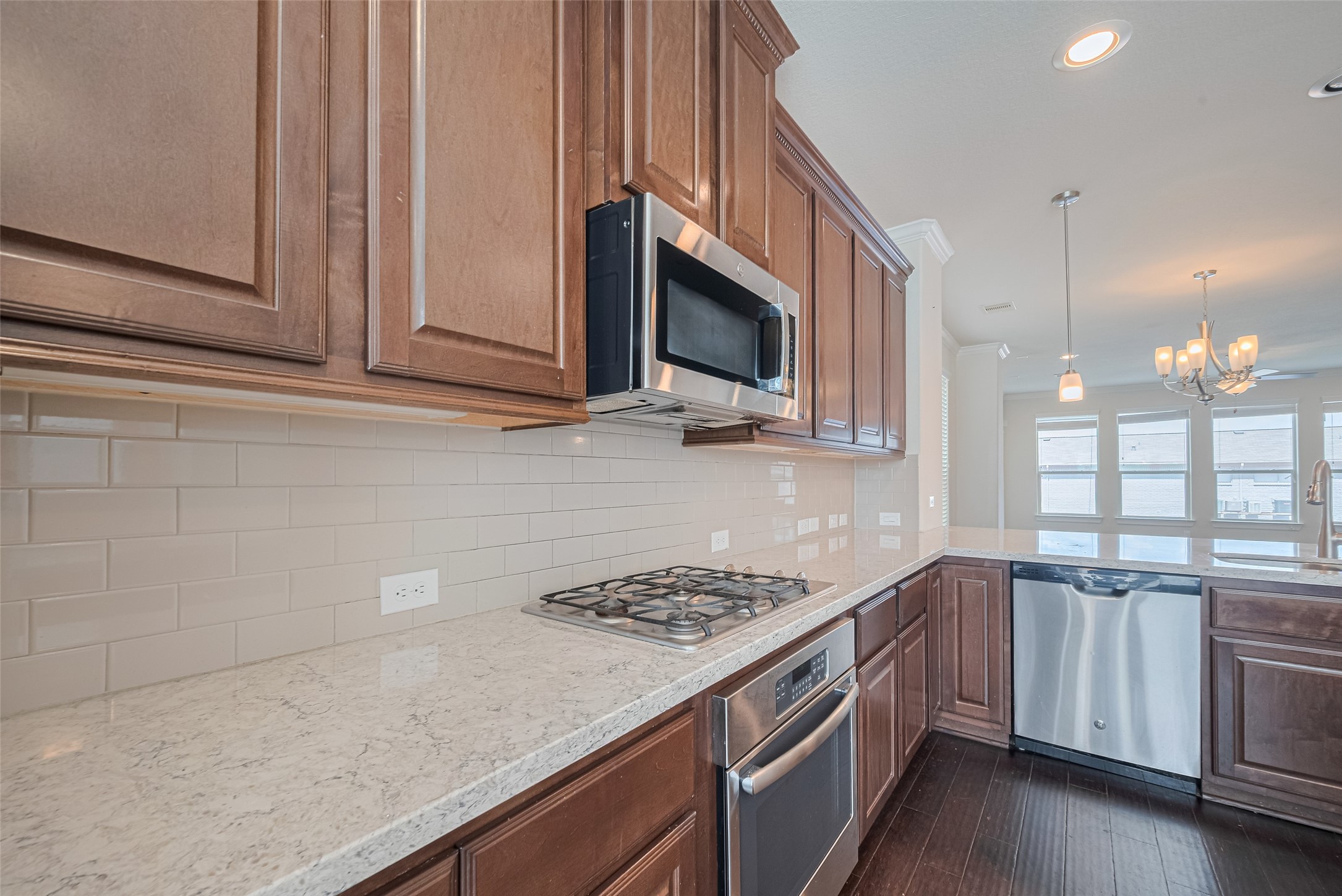 10004 Spring Shadows Park Circle Houston, TX 77080 - Photo 25 of 50 a kitchen with a sink stove and microwave