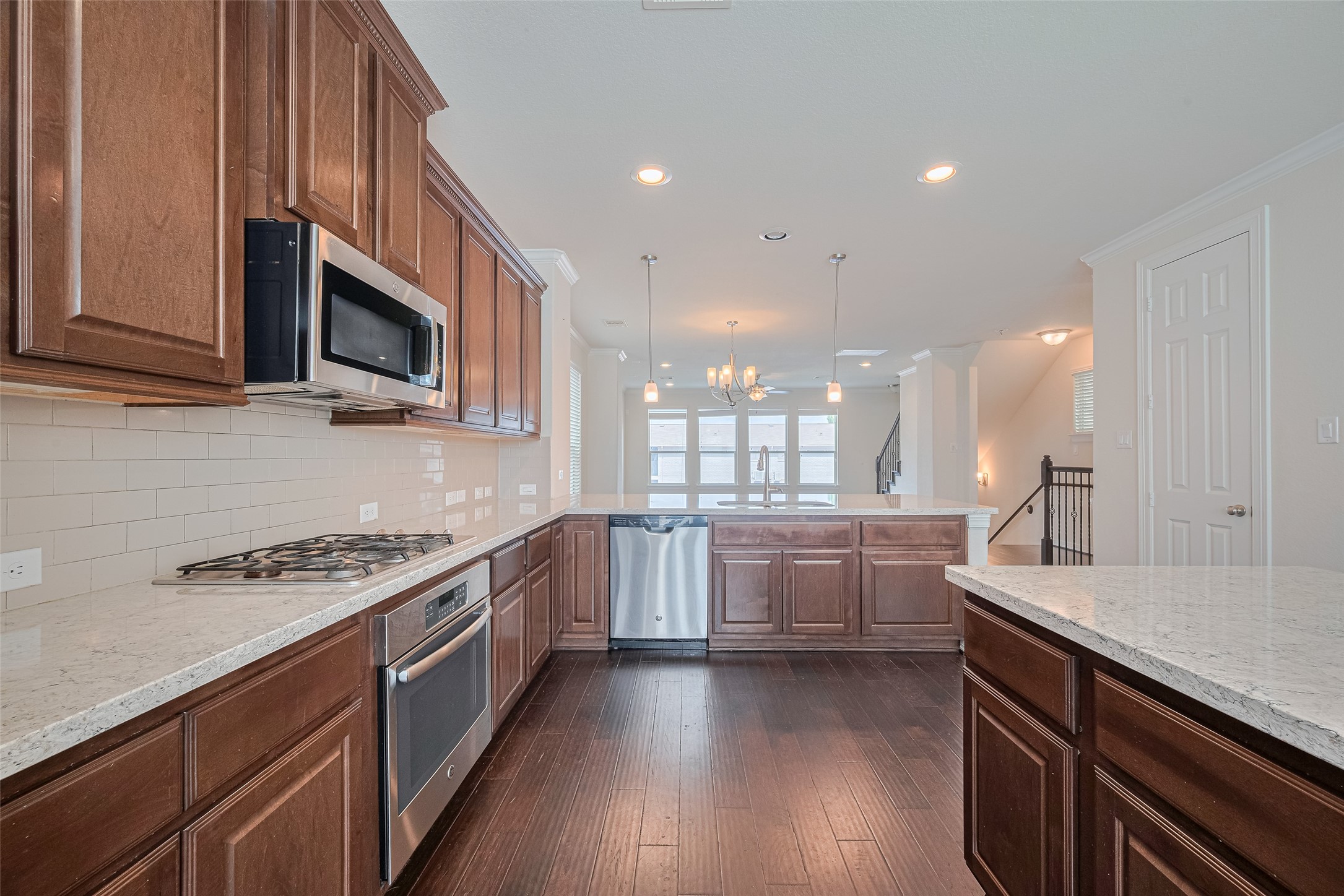 10004 Spring Shadows Park Circle Houston, TX 77080 - Photo 26 of 50 a kitchen with stainless steel appliances kitchen island granite countertop a sink a stove top oven a counter space and cabinets