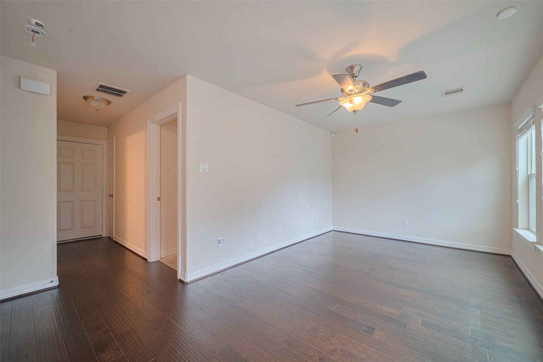 10004 Spring Shadows Park Circle Houston, TX 77080 - Photo 4 of 50 wooden floor in an empty room with a window