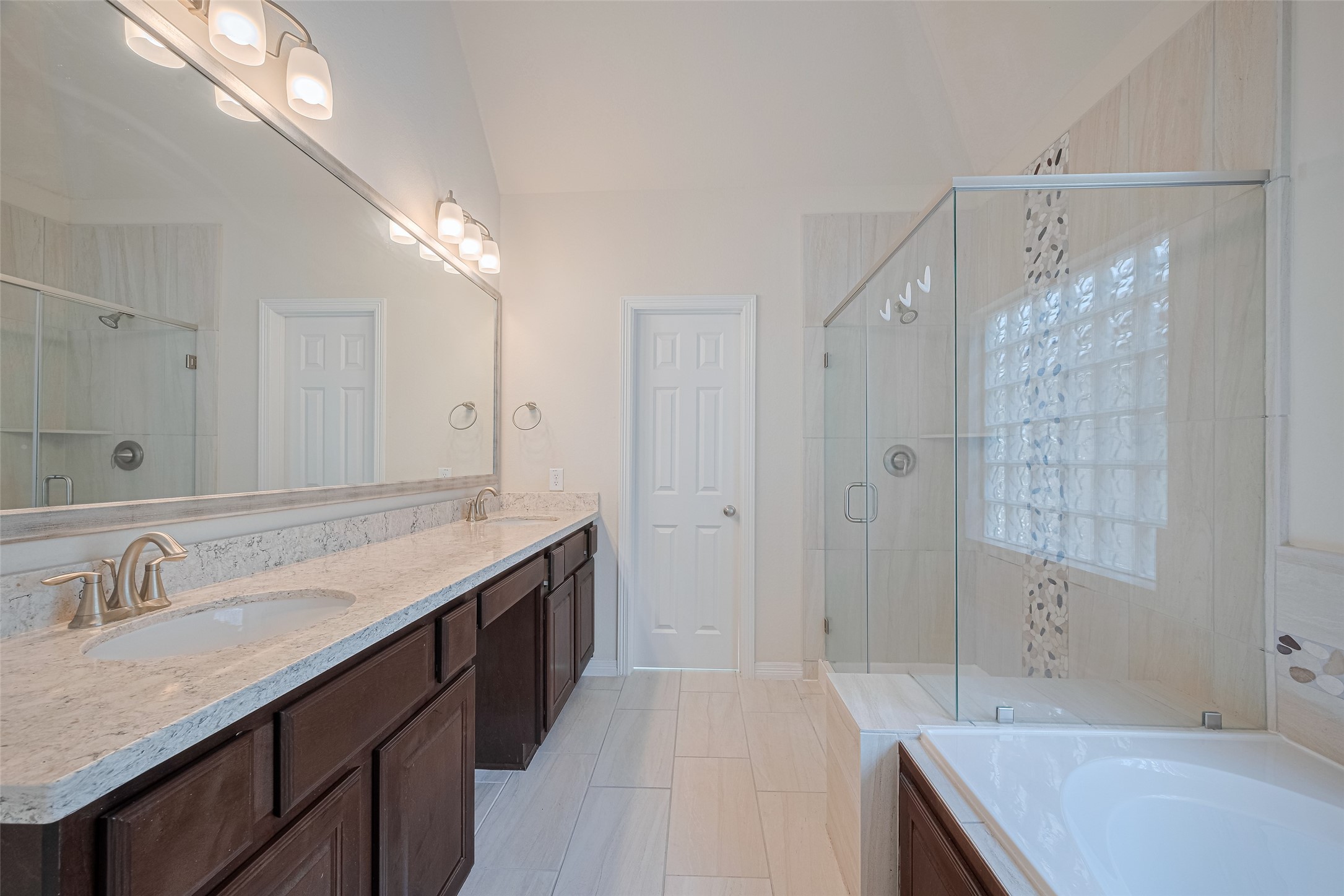 10004 Spring Shadows Park Circle Houston, TX 77080 - Photo 41 of 50 a spacious bathroom with a granite countertop sink a shower and a mirror