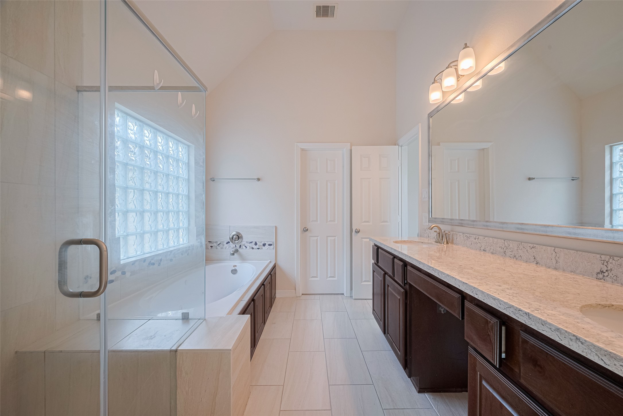 10004 Spring Shadows Park Circle Houston, TX 77080 - Photo 44 of 50 a spacious bathroom with a granite countertop sink a toilet a mirror and bathtub