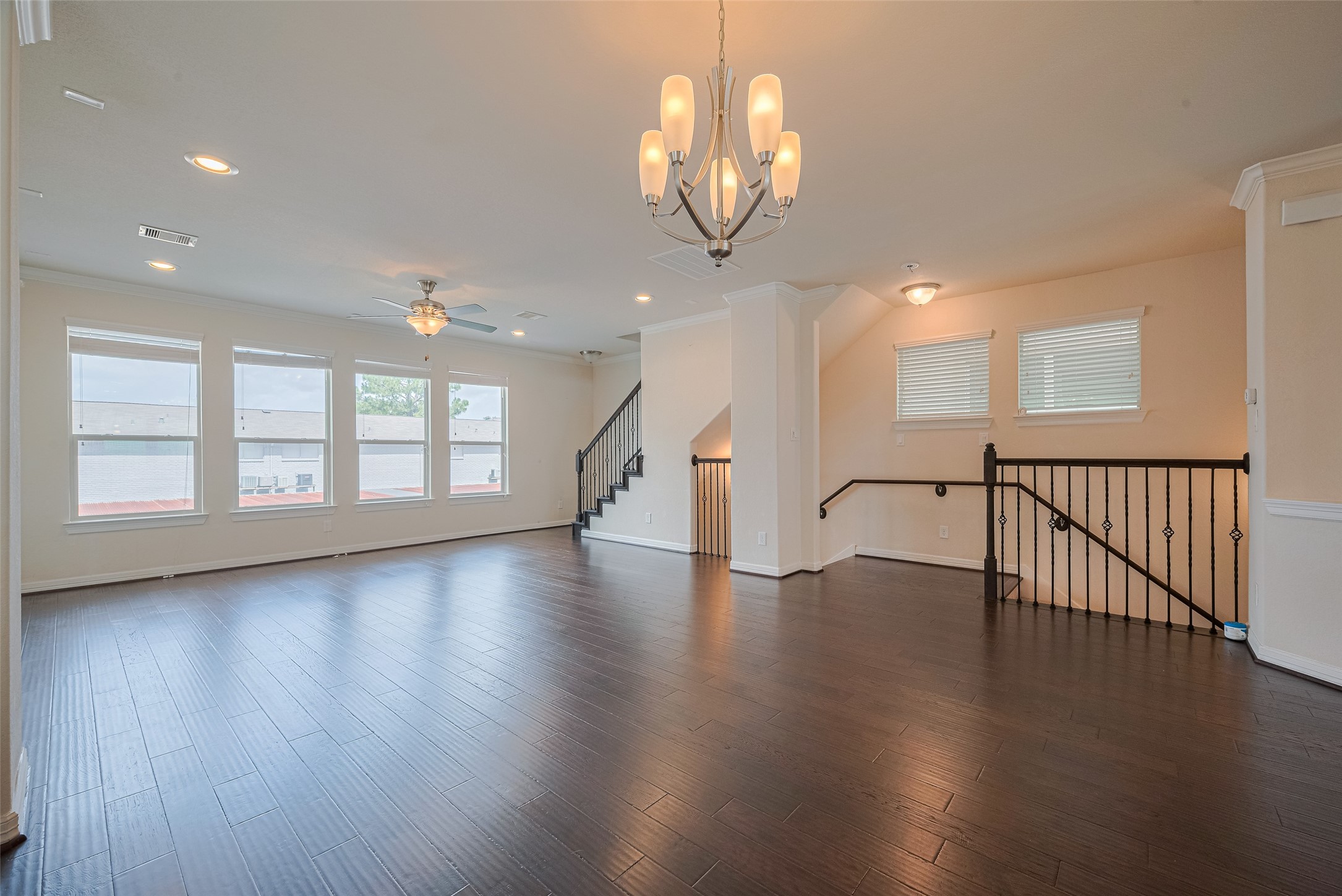 10004 Spring Shadows Park Circle Houston, TX 77080 - Photo 10 of 50 a view of an empty room with wooden floor and a large window