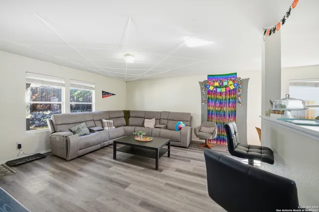a living room with furniture window and a flat screen tv