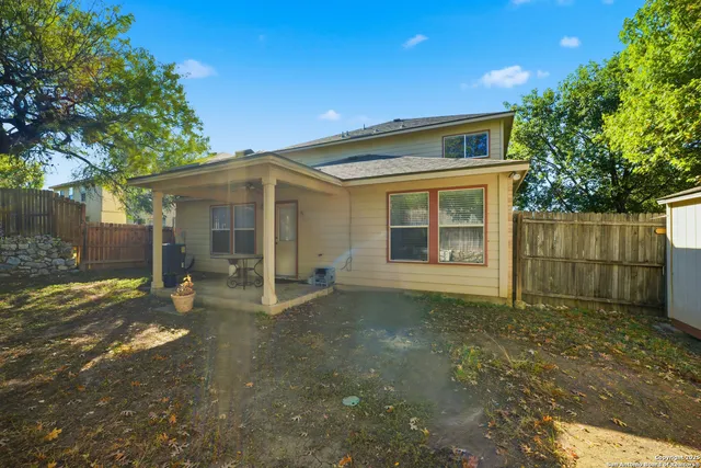a view of a house with a large window and large tree