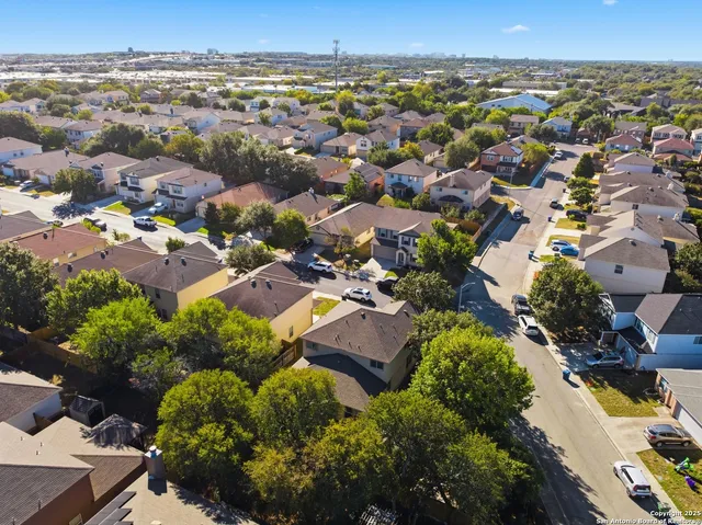 an aerial view of residential houses with outdoor space