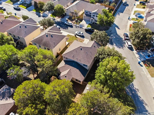 an aerial view of residential houses with outdoor space