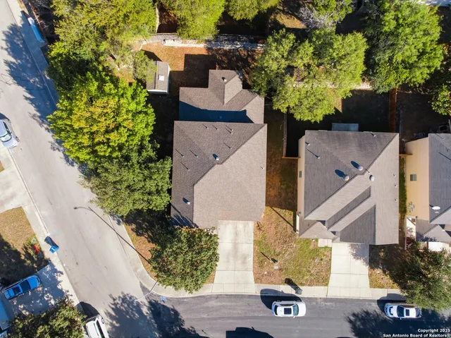 an aerial view of a house with a yard