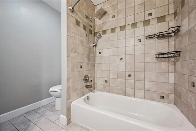 a bathroom with a bathtub and toilet