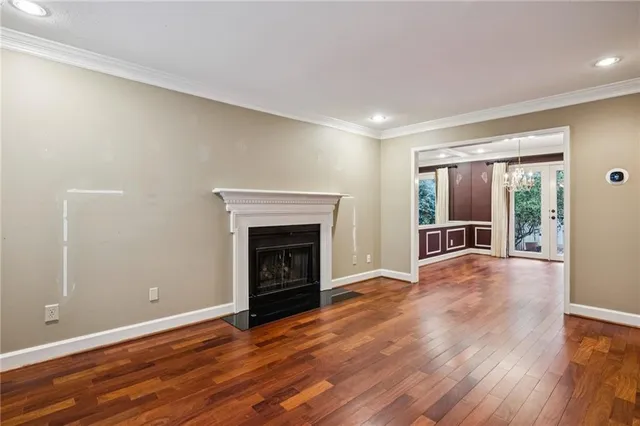 wooden floor fireplace and natural light in room