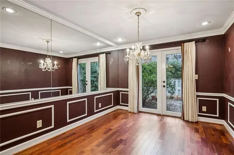 a view of a room with wooden floor and a ceiling fan