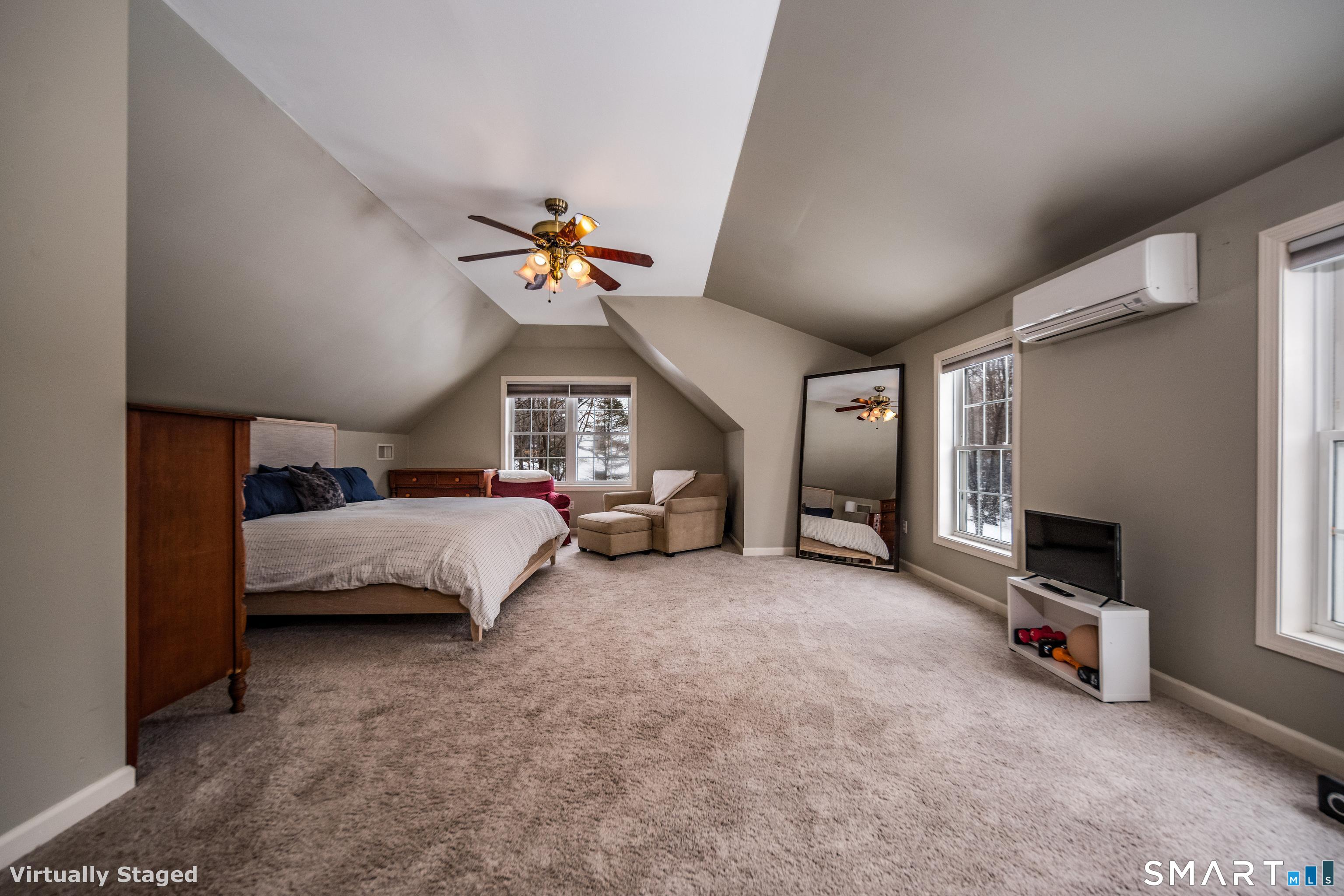 10 Stonewall Lane Clinton, CT 06413 - Photo 16 of 28 a spacious bedroom with a bed and a chandelier