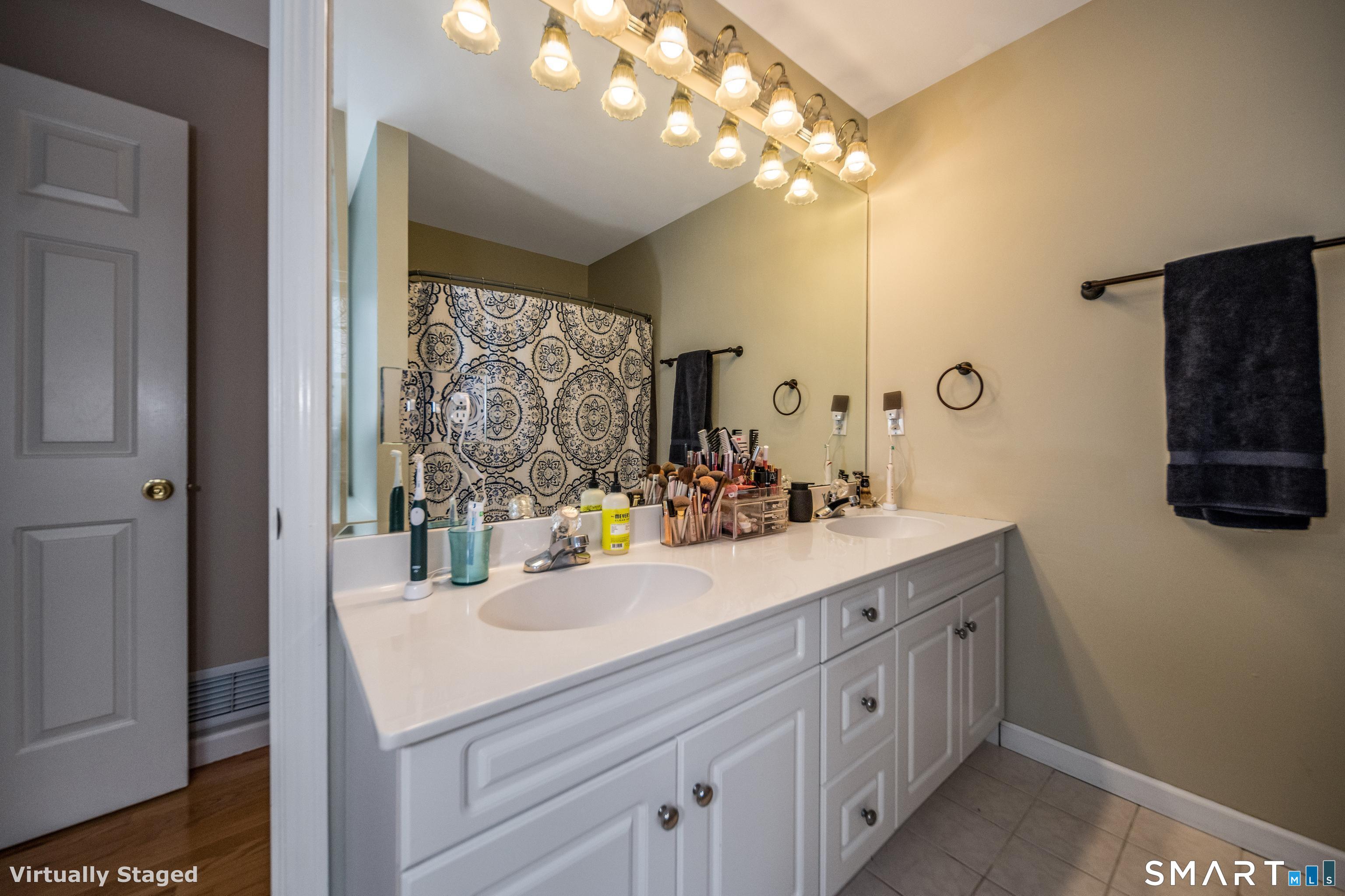 10 Stonewall Lane Clinton, CT 06413 - Photo 18 of 28 a bathroom with a sink a large mirror and a window