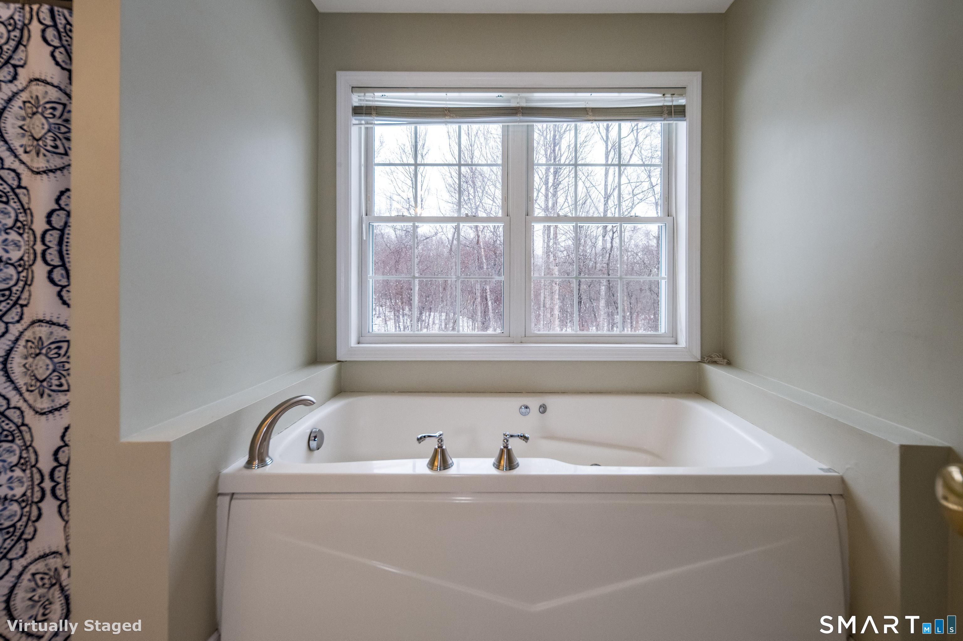 10 Stonewall Lane Clinton, CT 06413 - Photo 20 of 28 a bath tub sitting in a bathroom next to a window