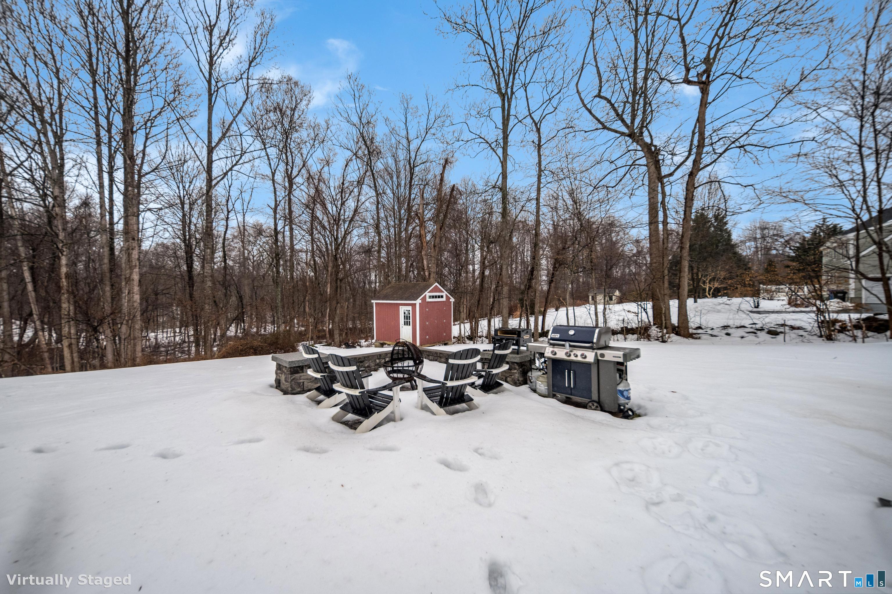 10 Stonewall Lane Clinton, CT 06413 - Photo 23 of 28 a view of a patio with a table and chairs under a large tree