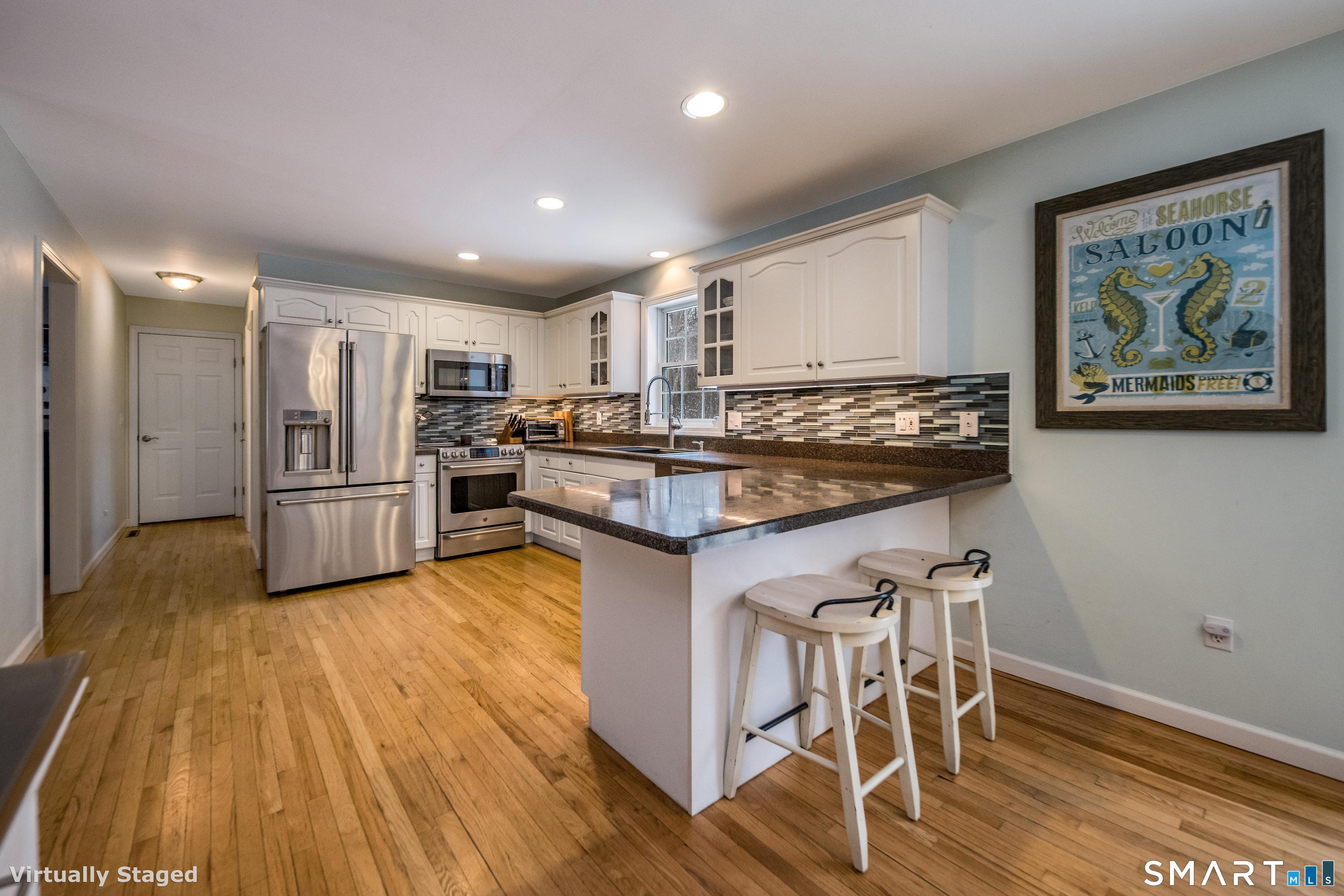10 Stonewall Lane Clinton, CT 06413 - Photo 6 of 28 a kitchen with stainless steel appliances granite countertop a stove and a refrigerator
