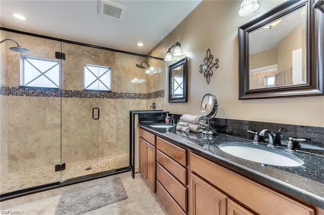 a bathroom with a granite countertop sink mirror and double