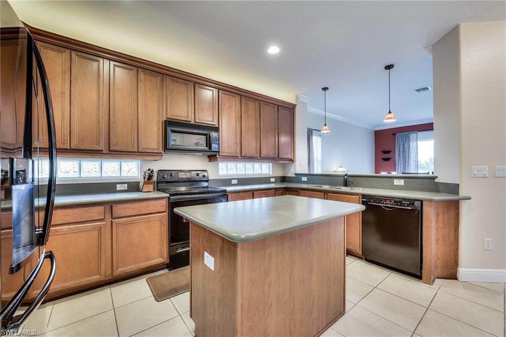 1970 Par Drive Naples, FL 34120 - Photo 2 of 26 a kitchen with stainless steel appliances granite countertop a stove a sink and a microwave
