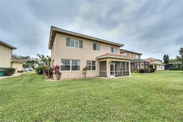 a view of a house with a yard and sitting area
