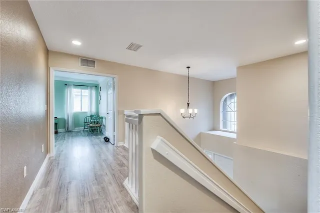 a view of a hallway view with wooden floor and staircase