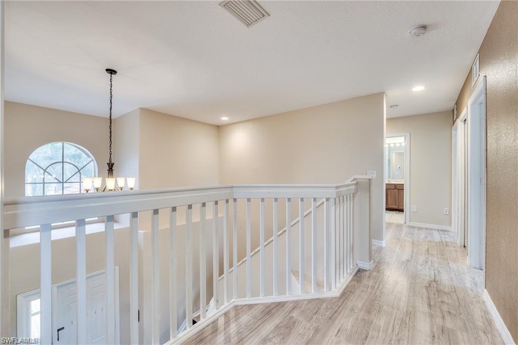 1970 Par Drive Naples, FL 34120 - Photo 8 of 26 a view of staircase with wooden floor