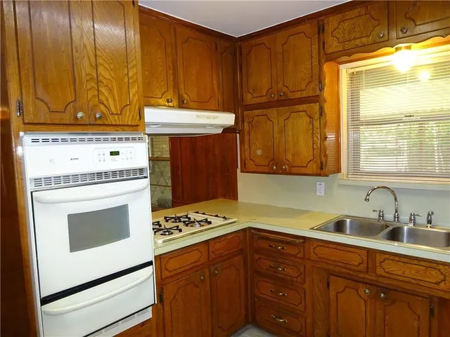 a kitchen with stainless steel appliances a stove a microwave and cabinets