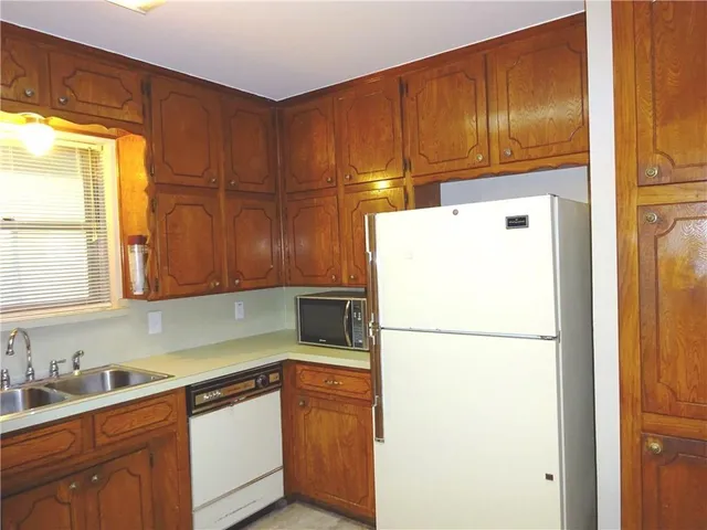 a kitchen with refrigerator and cabinets