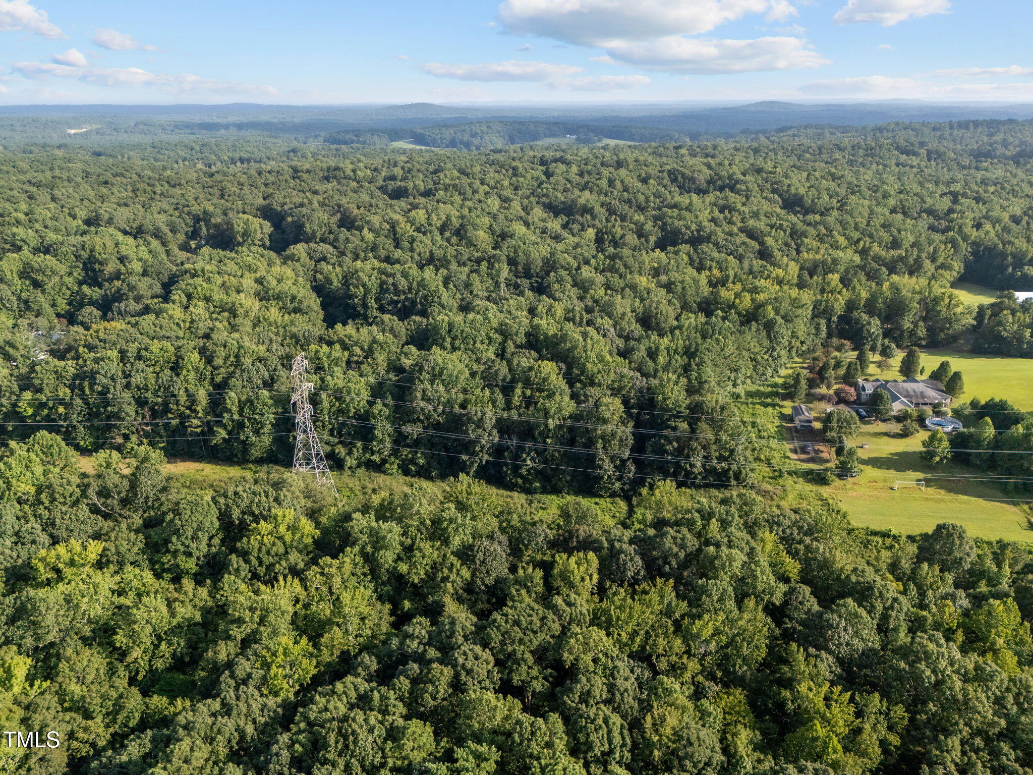 0 Davis Road Hillsborough, NC 27278 - Photo 6 of 12 an aerial view of residential houses with outdoor space and trees