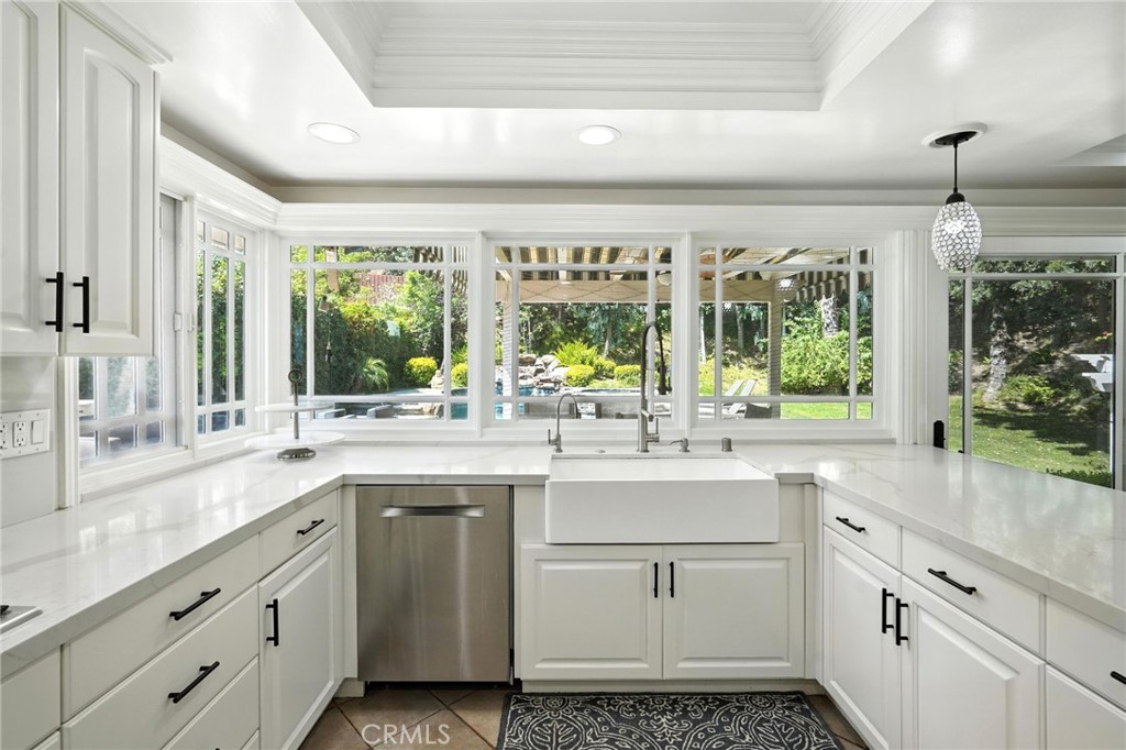 4141 Coldstream Terrace Tarzana, CA 91356 - Photo 11 of 41 a kitchen with sink cabinets and wooden floor