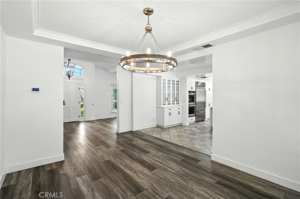 4141 Coldstream Terrace Tarzana, CA 91356 - Photo 12 of 41 a view of a hallway with wooden floor and a chandelier