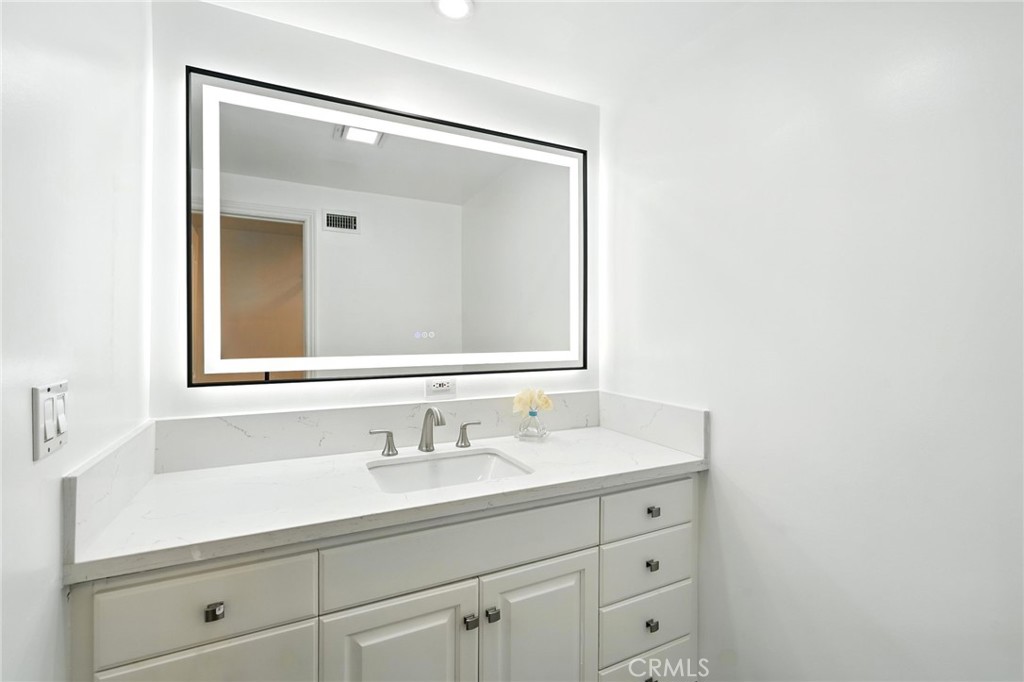 4141 Coldstream Terrace Tarzana, CA 91356 - Photo 15 of 41 a bathroom with a sink vanity and mirror